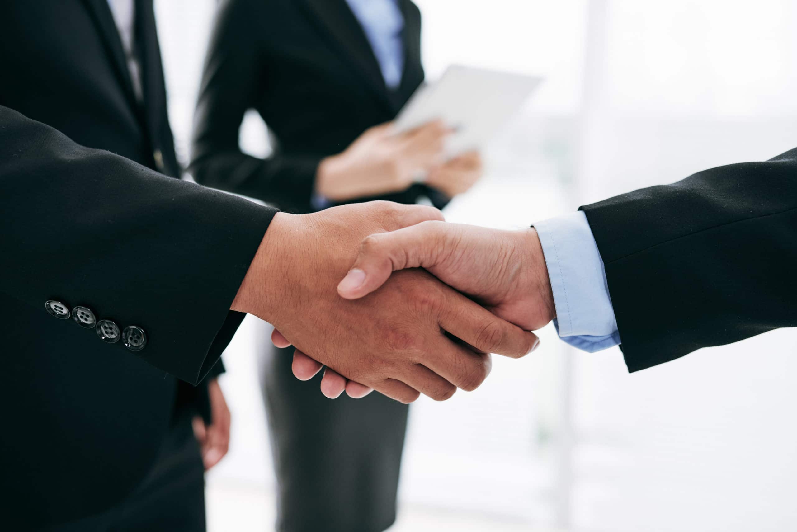 Business people shaking hands after successful deal